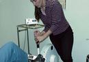 Physical therapist adjusting equipment